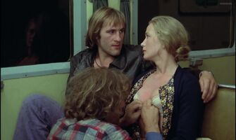 Brigitte Fossey lets two guys fondle her on a train